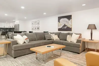 a living room with a couch and a table at Modern luxury mountain house in Fraser