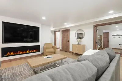 a living room with a couch and a fireplace at Modern luxury mountain house in Fraser
