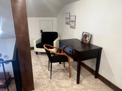 a room with a desk and a chair and a couch at Luxury Mountain Retreat in Fraser