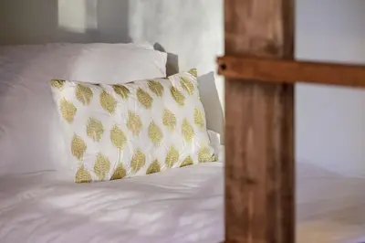 a white bed with a pillow on top of it at Luxury Mountain Retreat in Fraser