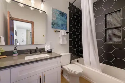 a bathroom with a sink and a toilet and a mirror at Luxury Mountain Retreat in Fraser