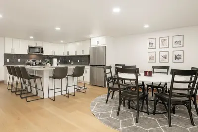 a kitchen with a table and some chairs and a counter at Stylish Mountain getaway in Fraser