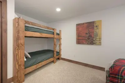 a bedroom with a bunk bed in a room at Stylish Mountain getaway in Fraser