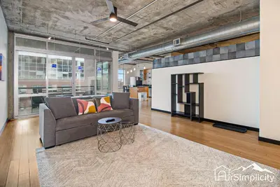 a living room with a couch and a table at Condo w pvt balcony & gym access in Denver