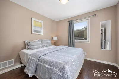 a bedroom with a large bed and a window at Quiet Denver retreat w hot tub & fireplace in Denver