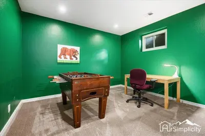 an office with green walls and a desk and a chair at Quiet Denver retreat w hot tub & fireplace in Denver