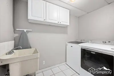 a kitchen with a sink and a washing machine at Quiet Denver retreat w hot tub & fireplace in Denver