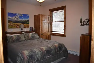 a bedroom with a bed and a window at Bears Den 1 - Hot Tub and Views! in Estes Park