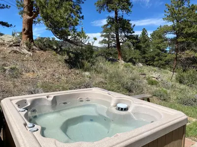 a jacuzzi tub in the middle of a field at Bears Den 1 - Hot Tub and Views! in Estes Park