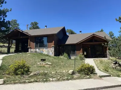 a large house with a yard in front of it at Bears Den 1 - Hot Tub and Views! in Estes Park