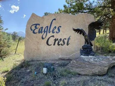 a sign with an eagle on top of a rock at Bears Den 1 - Hot Tub and Views! in Estes Park