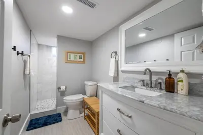 a white bathroom with a sink and a toilet at Light-filled retreat w hot tub & firepit in Denver