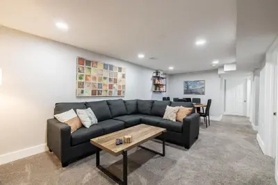 a living room with a couch and a table at Light-filled retreat w hot tub & firepit in Denver