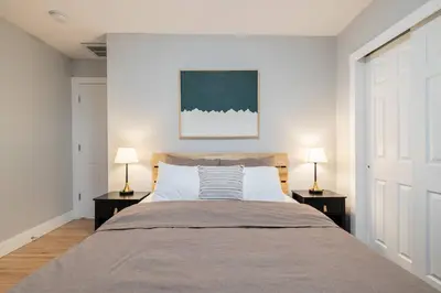 a bedroom with a large bed with two lamps at Light-filled retreat w hot tub & firepit in Denver
