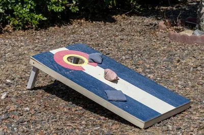 a surfboard with a number on it sitting on the ground at Light-filled retreat w hot tub & firepit in Denver