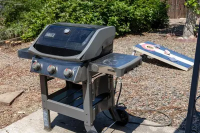 a bbq grill with a blue and silver at Light-filled retreat w hot tub & firepit in Denver