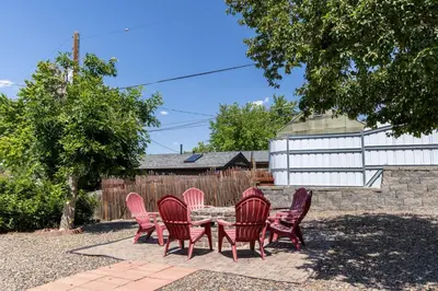 a group of red chairs sitting around a table at Light-filled retreat w hot tub & firepit in Denver