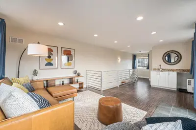 a living room with a couch and a table at Walk to Broncos Stadium Hot tub & Rooftop in Denver