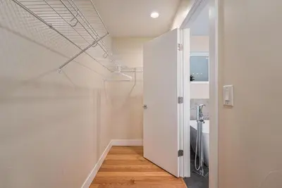 a bathroom with a white closet and a door at Walk to Broncos Stadium Hot tub & Rooftop in Denver