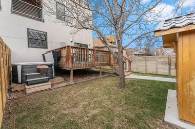 a house with a large deck with a grill at Walk to Broncos Stadium Hot tub & Rooftop in Denver