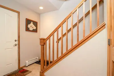 a staircase in a home with a wooden stair case at Cross Creek - Pool and Hot Tubs by Daniel in Frisco