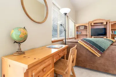 a room with a desk with a mirror and a couch at Cross Creek - Pool and Hot Tubs by Daniel in Frisco