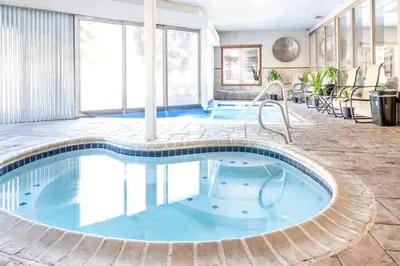 a pool in a hotel room with blue water at Cross Creek - Pool and Hot Tubs by Daniel in Frisco