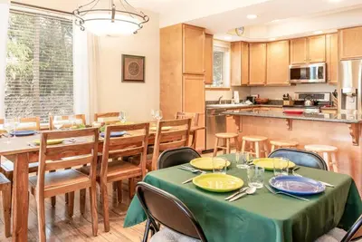 a kitchen and dining room with a table and chairs at Cross Creek - Pool and Hot Tubs by Daniel in Frisco