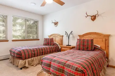a bedroom with two beds and a window at Cross Creek - Pool and Hot Tubs by Daniel in Frisco