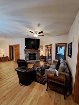 a living room with a couch and a fireplace at Beautiful 2BR in River Run - Kids Ski Free! condo in Dillon