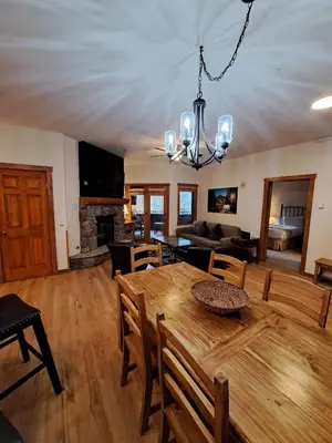 a dining room and living room with a table and chairs at Beautiful 2BR in River Run - Kids Ski Free! condo in Dillon