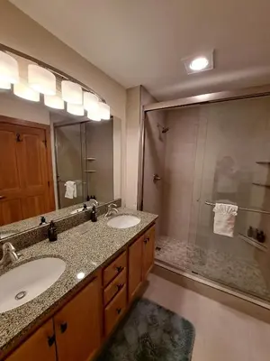 a bathroom with two sinks and a shower at Beautiful 2BR in River Run - Kids Ski Free! condo in Dillon