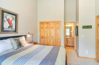 a bedroom with a bed and a wooden door at 6 Mi to Skiing Mtn-View Fraser Duplex in Fraser
