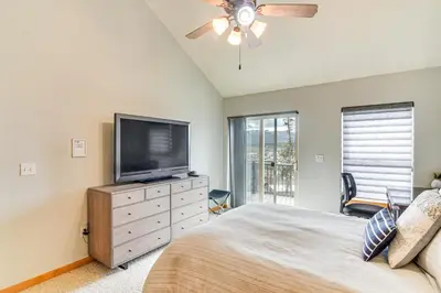 a bedroom with a bed and a flat screen tv at 6 Mi to Skiing Mtn-View Fraser Duplex in Fraser