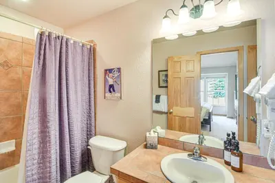 a bathroom with a sink and a toilet and a mirror at 6 Mi to Skiing Mtn-View Fraser Duplex in Fraser