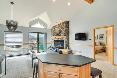 a living room with a table and a fireplace at 6 Mi to Skiing Mtn-View Fraser Duplex in Fraser