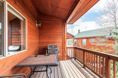 a porch with a grill and a picnic table on it at Lookout Ridge 45 by Great Western Lodging in Dillon