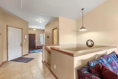 a living room with a couch and a kitchen at Lookout Ridge 45 by Great Western Lodging in Dillon