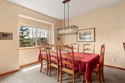 a dining room with a red table and chairs at Lookout Ridge 45 by Great Western Lodging in Dillon