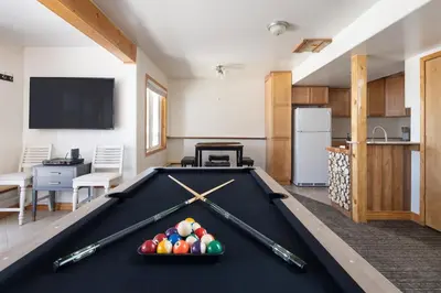a pool table with balls on it in a room at Mountain View Retreat home in Nederland