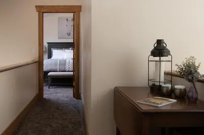 a room with a bed and a table with a lamp at Mountain View Retreat home in Nederland