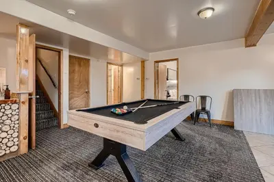 a pool table in a living room with a pool at Mountain View Retreat home in Nederland