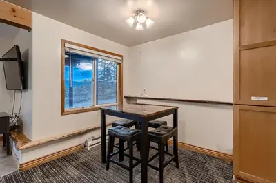 a dining room with a table and a window at Mountain View Retreat home in Nederland