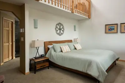 a bedroom with a bed with a wooden head board at Lookout Lodge in Wondervu home in Nederland