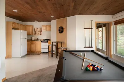 a kitchen with a pool table in a room at Lookout Lodge in Wondervu home in Nederland