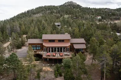 an aerial view of a house on a hill at Lookout Lodge in Wondervu home in Nederland