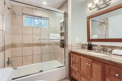 a bathroom with a tub and a shower and a sink at Nederland Mountain Haven bungalow in Nederland