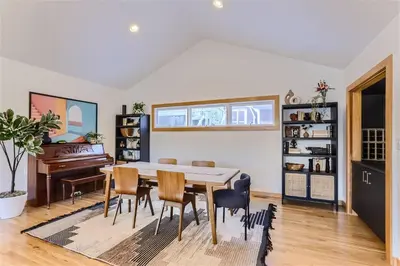 a dining room with a table and chairs and a piano at Nederland Mountain Haven bungalow in Nederland