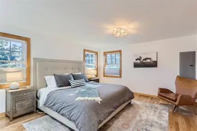 a bedroom with a bed and a chair at Nederland Mountain Haven bungalow in Nederland