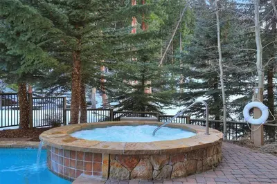 a hot tub in the middle of a park at Ski In, Ski Out 3 Bedroom At Lone Eagle In River Run in Dillon